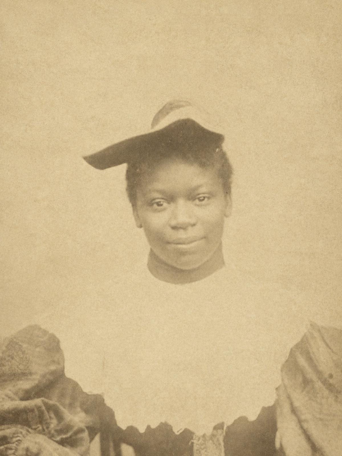 A carte de visite portrait of a young woman in a feathered hat, covered in brown foxing spots and fine scratches with a pale chip beside her mouth, and the same portrait restored with the spots and scratches gone